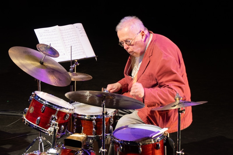 close-up of Spike Wells playing drums.